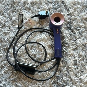 Dyson hair dryer with case and attachments.